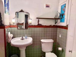 a bathroom with a sink and a toilet at Cozy Farm House with River access in Three Rivers +30 photos