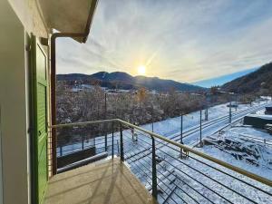 a balcony with a view of a snow covered field at Nos Sweet Home in Dimaro