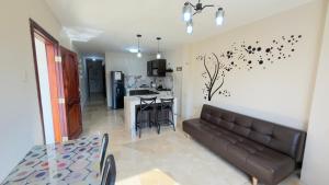 a living room with a couch and a kitchen at NCG Suite in Guayaquil
