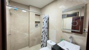 a bathroom with a shower and a toilet and a sink at NCG Suite in Guayaquil +112 photos