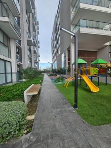 a playground in a apartment building with a slide at GabyMar salinas del mar Santamarta in Santa Marta