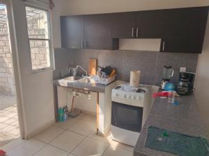 a kitchen with a white stove and a sink at Casa Roque in El Balcón