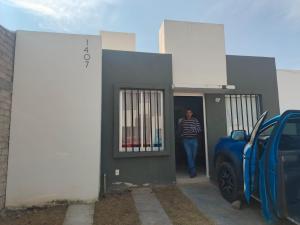 a man walking out of a building with a door at Casa Roque in El Balcón