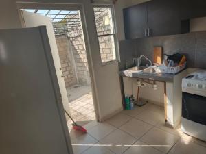 a kitchen with a mop on the floor next to a sink at Casa Roque in El Balcón +4 photos