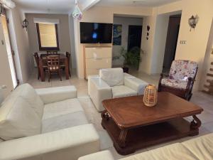 a living room with white furniture and a table at R Limoli Cozy in Trávnica