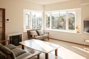 a living room with a couch and a table at garden villa 月灯tsukibi in Shiraoi