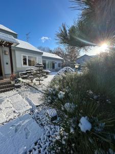 a house with snow on the ground in a yard at garden villa 月灯tsukibi in Shiraoi +26 photos