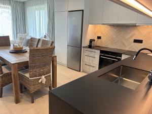 a kitchen and dining room with a table and refrigerator at Ayïa suites in Alikanas