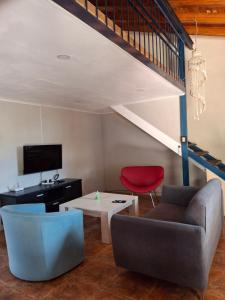 a living room with a couch and a table at Casa con Piscina -El nogal in Las Heras