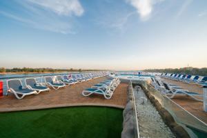 a row of chaise lounge chairs on a cruise ship at فندق نايل ستوري سوهاج in Sūhāj