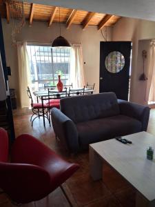 a living room with a couch and a table at Casa con Piscina -El nogal in Las Heras