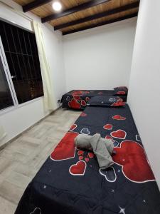 a bedroom with a bed with hearts on it at Casa con Piscina -El nogal in Las Heras