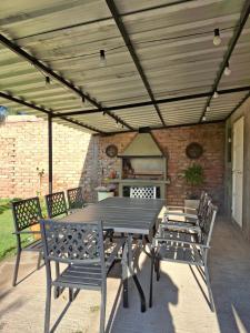 a patio with a table and chairs and a stove at Casa con Piscina -El nogal in Las Heras +13 photos