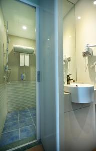 a bathroom with a shower and a sink and a mirror at Half-City Homestay in Xi'an +42 photos