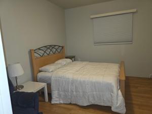 a small bedroom with a bed and a window at 2 bdrms Close to Health Science in Winnipeg