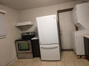 a kitchen with a white refrigerator and a microwave at 2 bdrms Close to Health Science in Winnipeg +1 photo