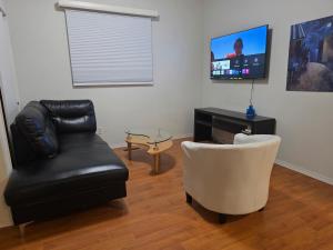a living room with a couch and a chair and a television at 2 bdrms Close to Health Science in Winnipeg