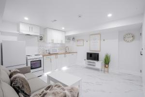 a white living room with a couch and a table at Bright Modern 1BR Suite Free Parking Fast WiFi Self Check-In in Bowmanville +10 photos
