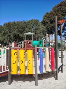 a playground with colorful plastic cylinders on a beach at Lakeside view in Cuthbert