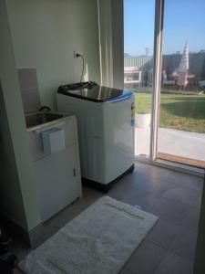 a kitchen with a refrigerator and a sink and a window at Lakeside view in Cuthbert +68 photos