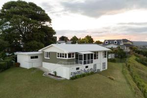 an aerial view of a house with a yard at The Hilltop Hideaway in Tauranga