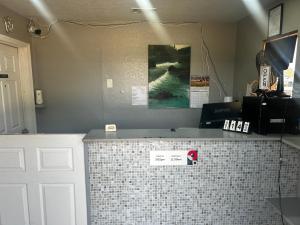 a kitchen with a counter with a tiled counter top at Coachman's Inn & Suites in Waldron