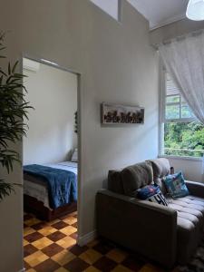 a living room with a couch and a bed at Palácio Quitandinha in Petrópolis