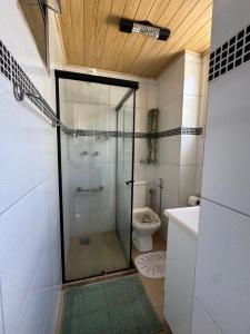 a bathroom with a glass shower with a toilet at Palácio Quitandinha in Petrópolis