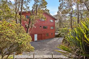 a red barn with a driveway in front of it at Stop Looking You've found it in Volcano