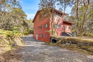 a red barn with a gravel road in front of it at Stop Looking You've found it in Volcano +59 photos