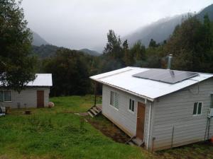a house with a solar panel on top of it at Cabañas Uenke in Puerto Puyuhuapi