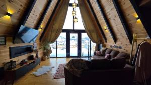 a living room with a couch and a flat screen tv at Cottage MATEJ in Podgorica
