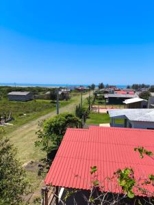 a view of a farm with a red roof at Beach house - Praia Recreio Torres in Torres
