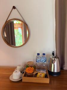 a tray of food and water bottles on a table at Wana Ayu Jelijih Villas by Dhananjaya Hospitality in Tampaksiring