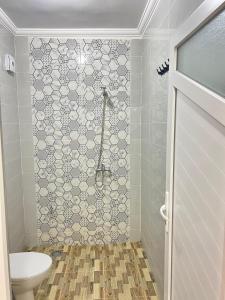 a bathroom with a shower and a toilet in it at Residence Almahaj in Laayoune +12 photos