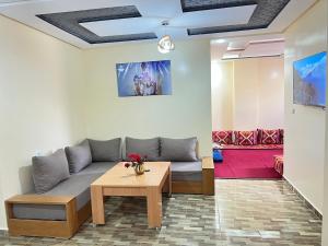 a living room with a couch and a table at Residence Almahaj in Laayoune