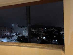 a view of a city at night at Flat com Ar, Piscina, Garagem, Cozinha e Wi-Fi in Campo Grande