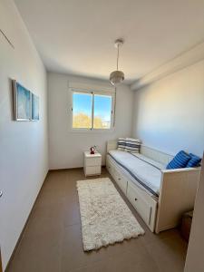 a bedroom with a bed and a window at PRECIOSO APARTAMENTO PLAYA DE PILES in Piles +24 photos