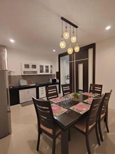 a kitchen and dining room with a table and chairs at Chotam House in Nathon Bay