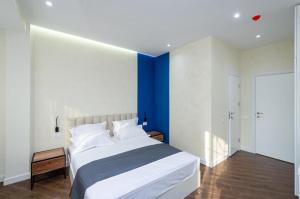 a bedroom with a large bed with a blue wall at Mashtots Avenue 31 in Yerevan