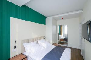 a bedroom with a bed with a green wall at Mashtots Avenue 31 in Yerevan