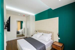 a bedroom with a green accent wall and a bed at Mashtots Avenue 31 in Yerevan +8 photos