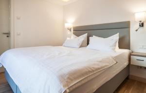 a bedroom with a large white bed with two pillows at Garden Suite in Binz