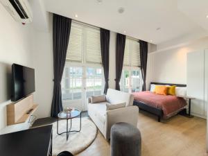 a living room with a bed and a couch at The White House - Serviced Residences by Cove & Belle Living in Singapore