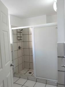 a shower with a glass door in a bathroom at Sierra 5 in Acapulco