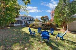 a group of blue chairs sitting in a yard at Tidepools Retreat Poolside Family Fun in York