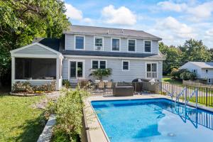 a house with a swimming pool in front of a house at Tidepools Retreat Poolside Family Fun in York