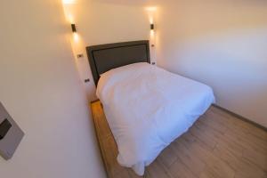 a small bedroom with a white bed in a room at Cabaña El Quillay in Santa Cruz
