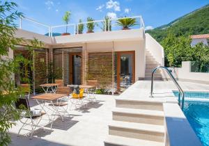 a villa with a swimming pool and a house at Boutique Hotel and Spa Blanc & Bleu - Blanche in Herceg-Novi