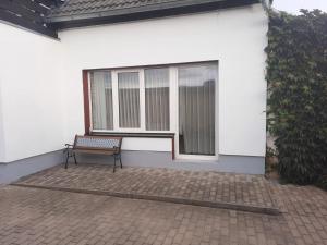 a bench sitting in front of a window at Ferienwohnung Brockenblick in Halberstadt